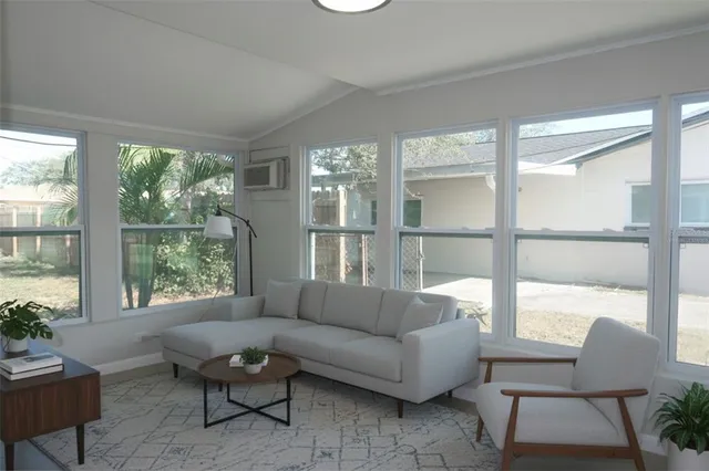 a living room with furniture and a large window