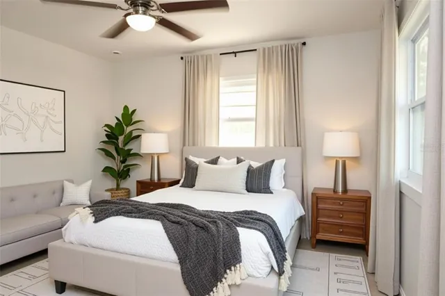 a bedroom with a bed a chandelier and a window