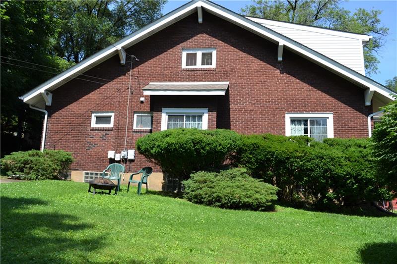 408 Cascade Road Pittsburgh, PA 15221 - Photo 3 of 25 The side of the spacious brick home features an additional off-street one car parking pad, perfect for guests!