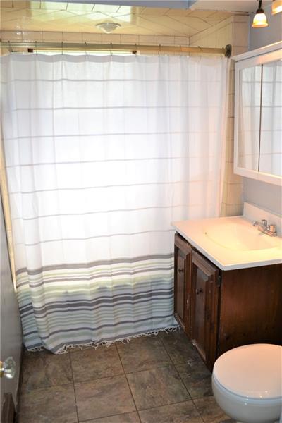 408 Cascade Road Pittsburgh, PA 15221 - Photo 24 of 25 FULL BATHROOM/1st floor/ This full bathroom conveniently located on the first floor features a tub/shower combination and is just off of the two first floor bedrooms.