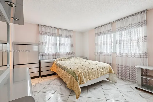 a spacious bedroom with a bed and a window