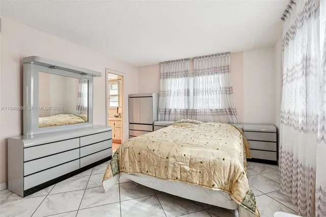 a bedroom with a bed and a mirror on dresser