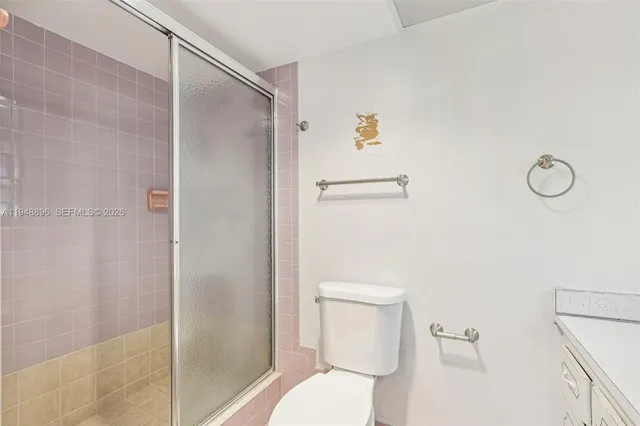 a white toilet sitting next to a bathroom sink
