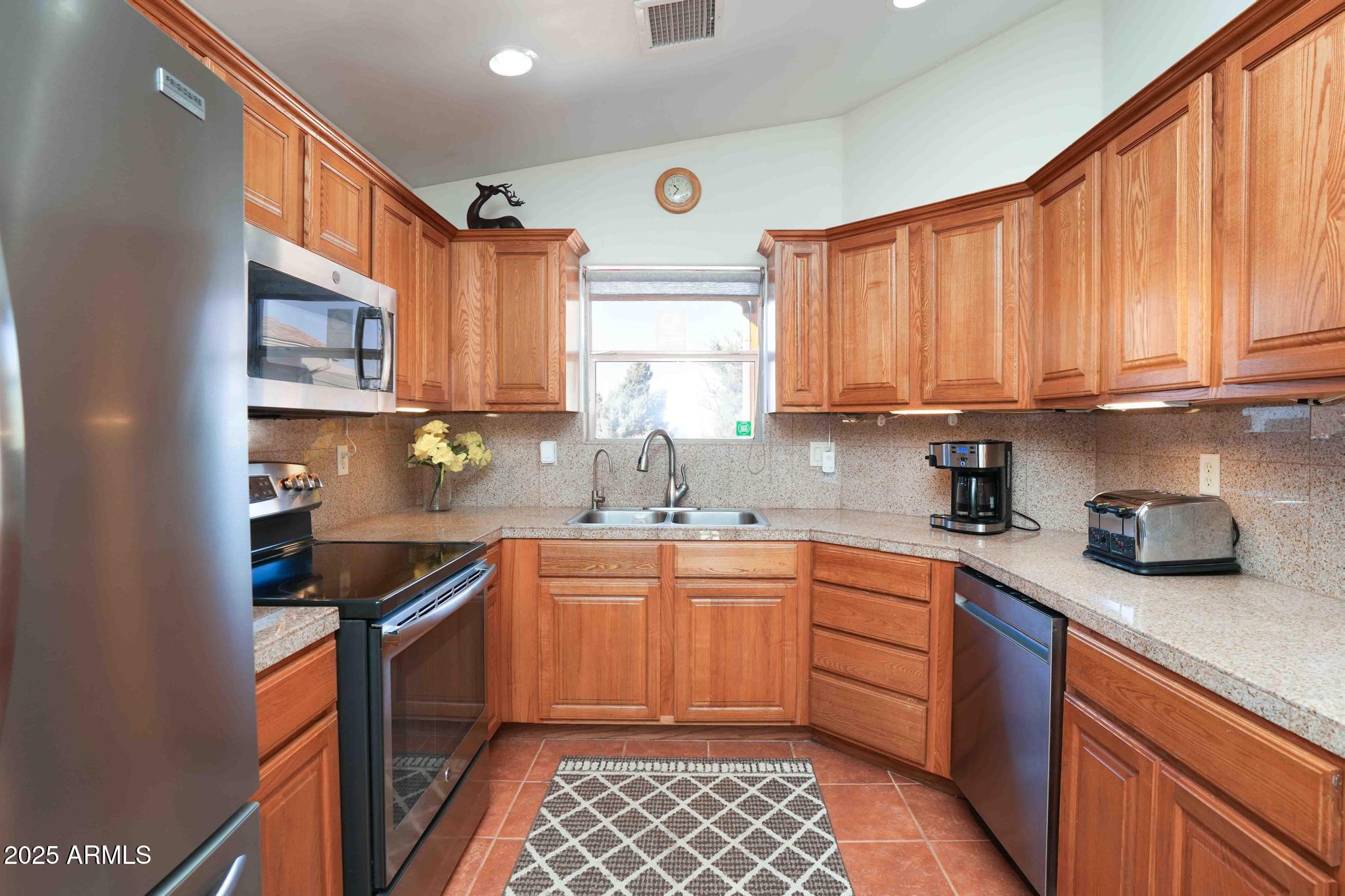 5775 North Kramer Drive Rimrock, AZ 86335 - Photo 11 of 33 a kitchen with stainless steel appliances granite countertop a sink stove and cabinets