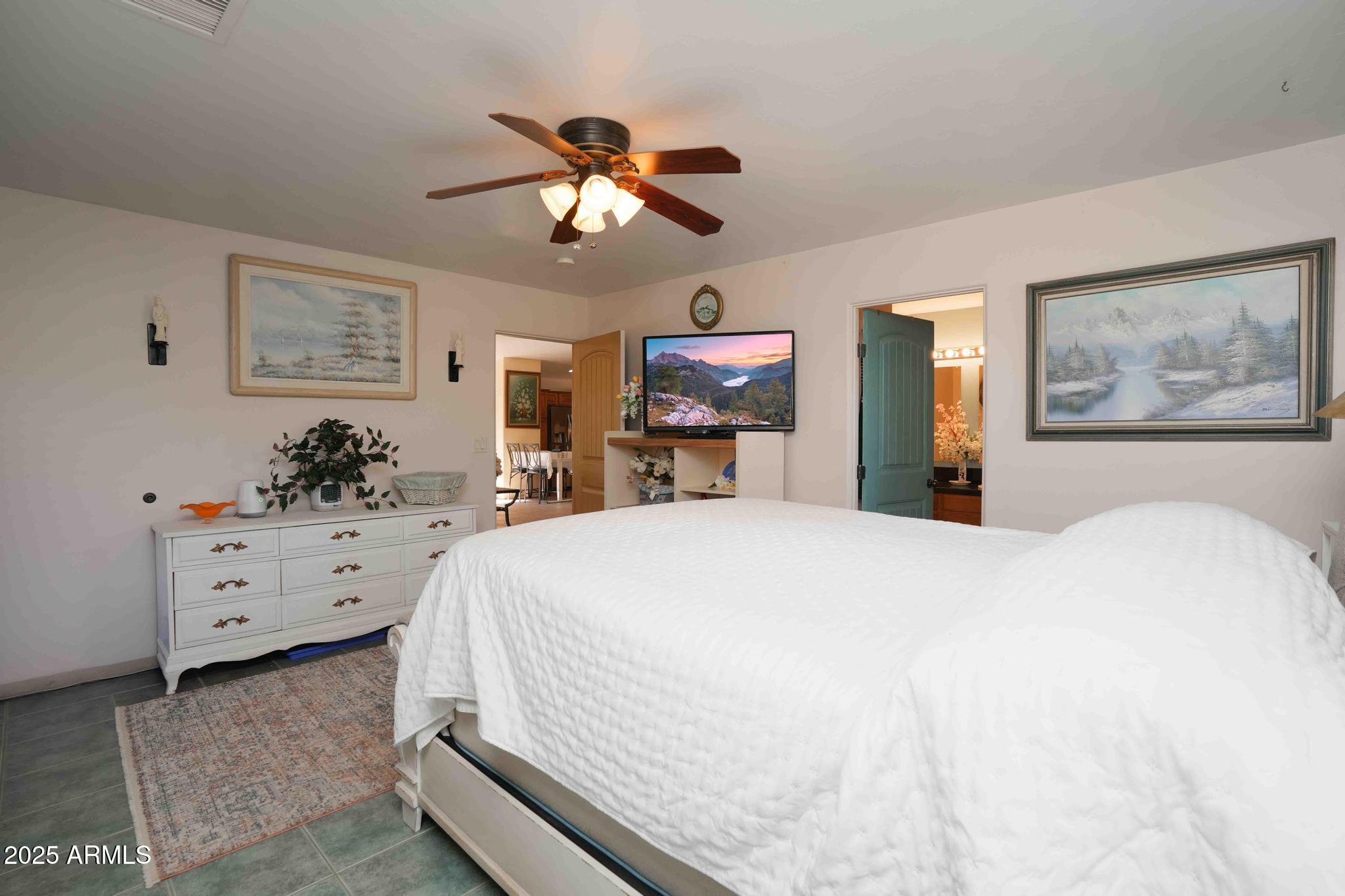 5775 North Kramer Drive Rimrock, AZ 86335 - Photo 15 of 33 a bed room with a bed mirror and a chandelier