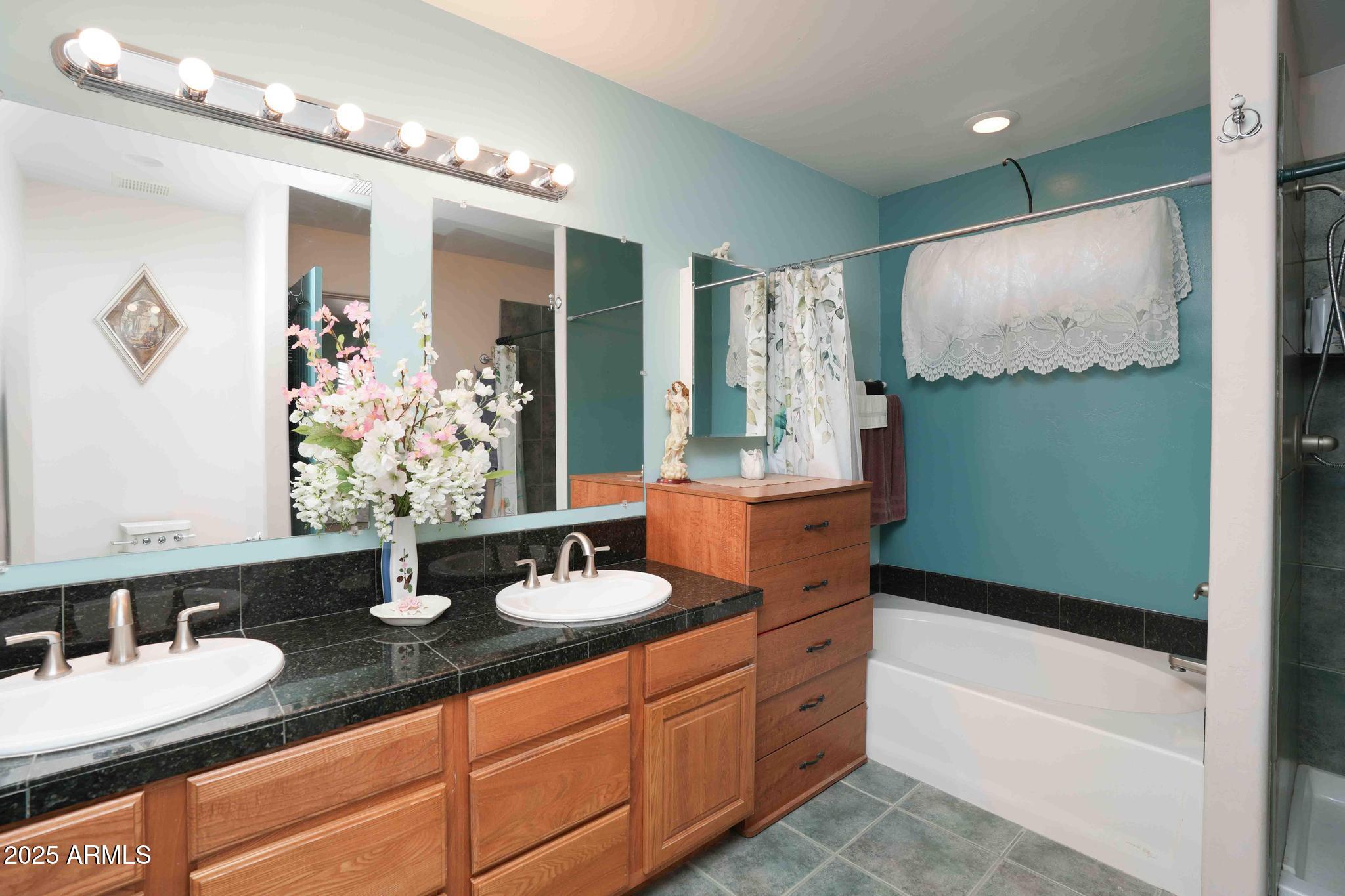 5775 North Kramer Drive Rimrock, AZ 86335 - Photo 16 of 33 a bathroom with a granite countertop sink and a mirror