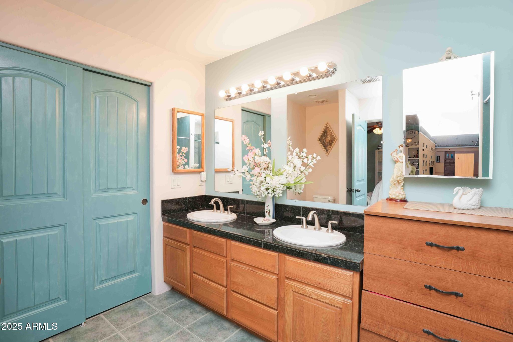 5775 North Kramer Drive Rimrock, AZ 86335 - Photo 18 of 33 a bathroom with a double vanity sink and a mirror
