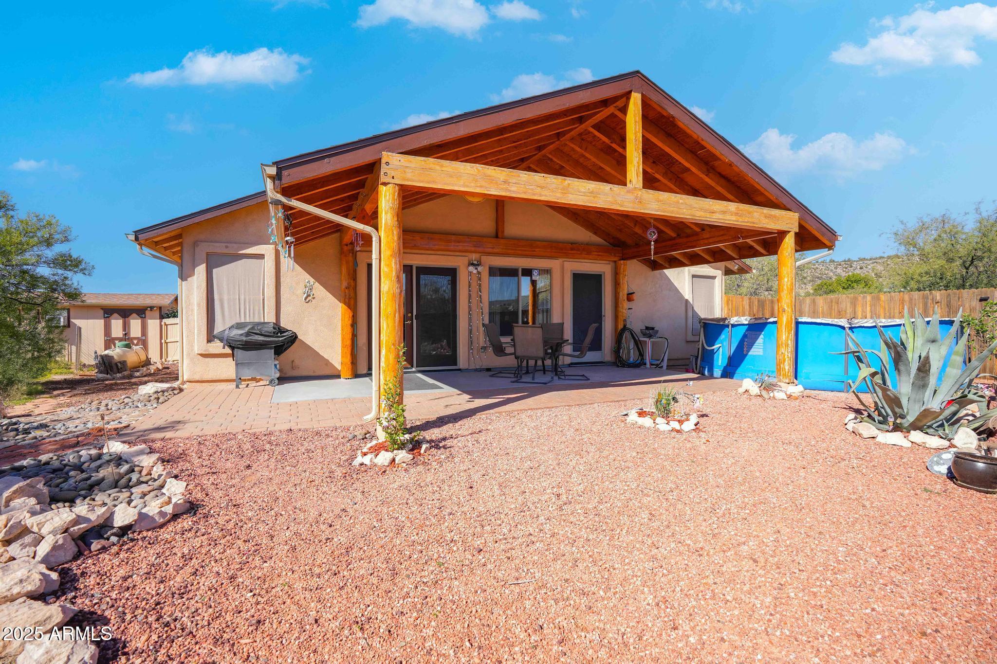 5775 North Kramer Drive Rimrock, AZ 86335 - Photo 24 of 33 a view of a house with floor to ceiling windows and a table
