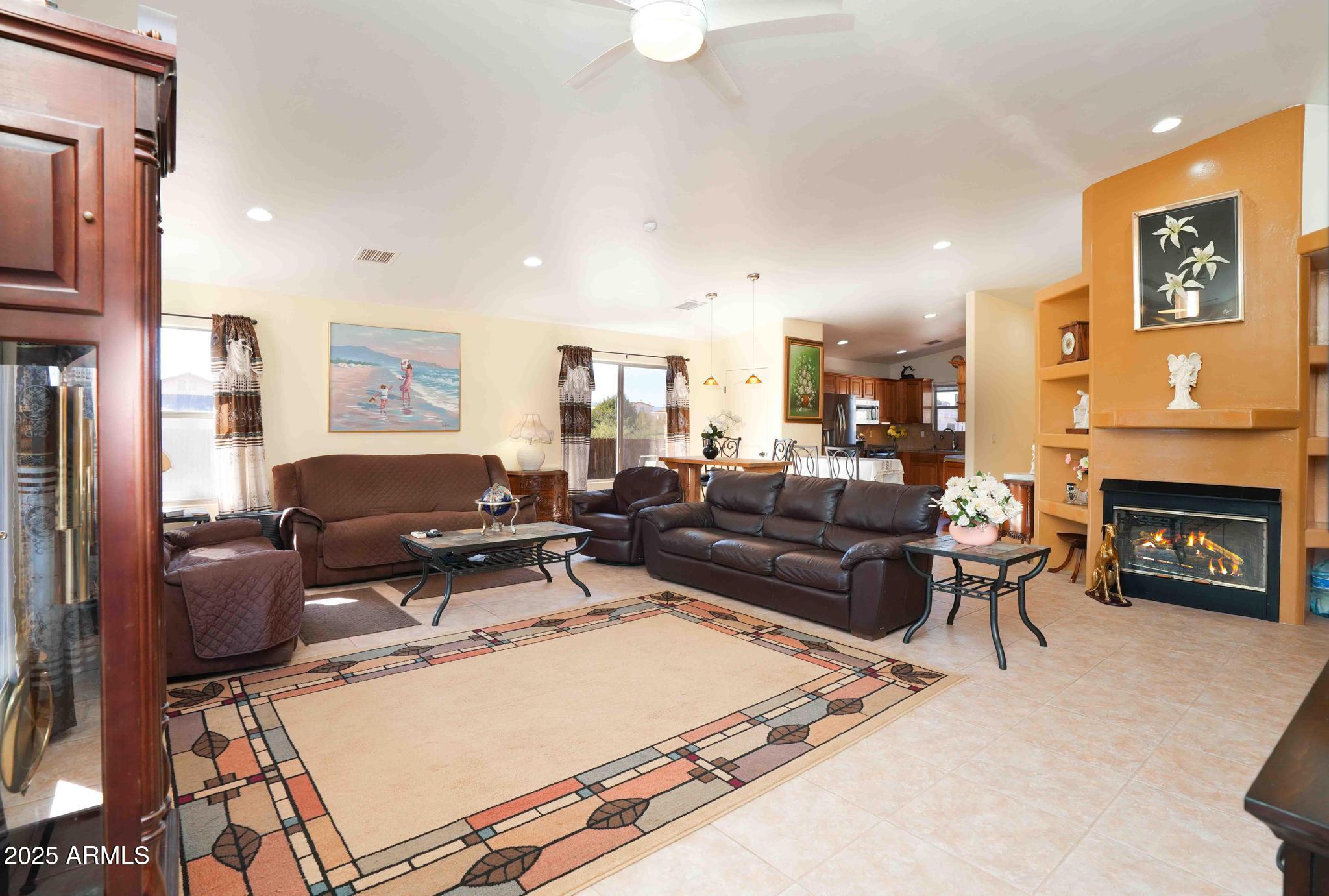 5775 North Kramer Drive Rimrock, AZ 86335 - Photo 6 of 33 a living room with furniture a fireplace and a flat screen tv