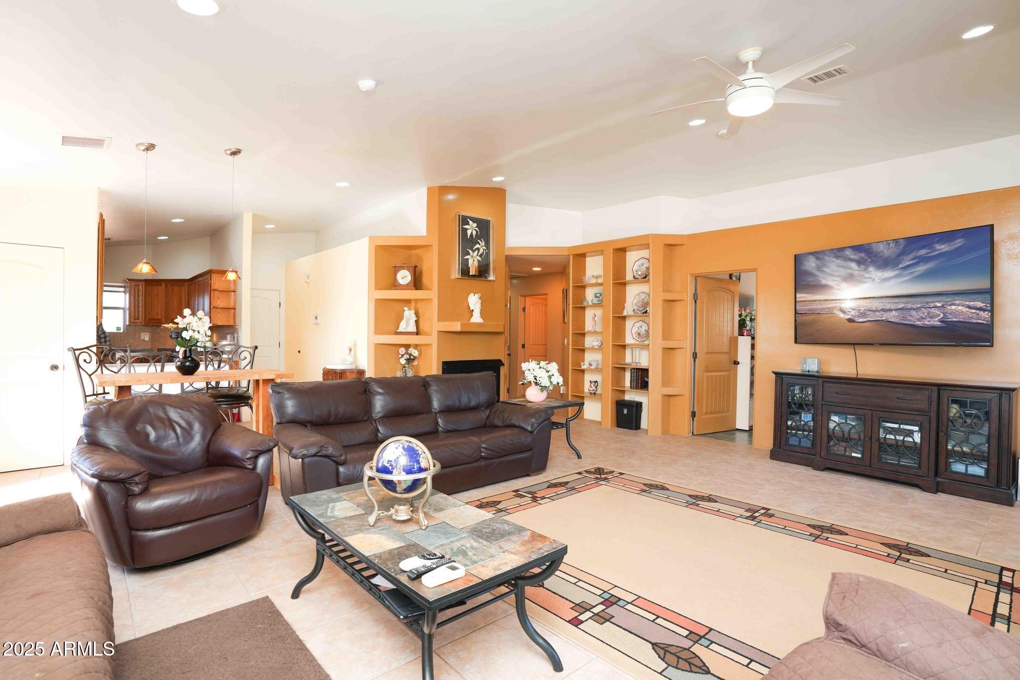 5775 North Kramer Drive Rimrock, AZ 86335 - Photo 7 of 33 a living room with furniture a flat screen tv and a fireplace