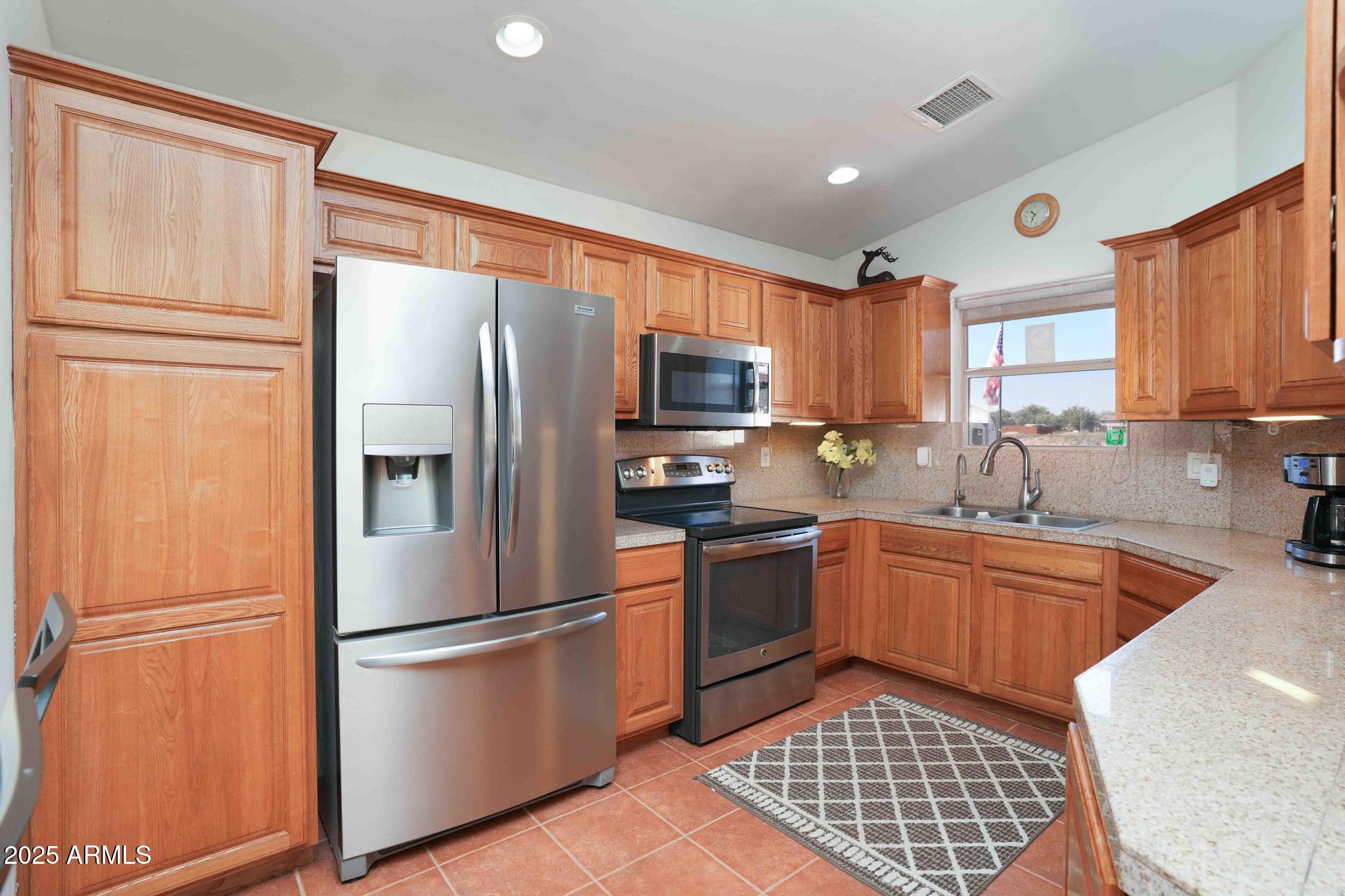 5775 North Kramer Drive Rimrock, AZ 86335 - Photo 10 of 33 a kitchen with granite countertop stainless steel appliances a refrigerator cabinets and a window