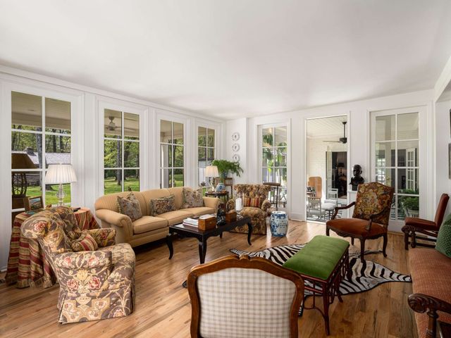 a view of a dining room with furniture wooden floor and chandelier