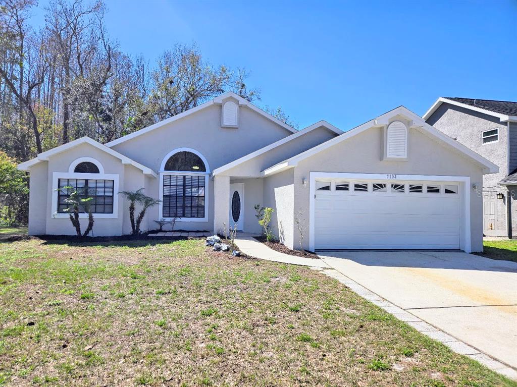 7104 Hummingbird Lane New Port Richey, FL 34655 - Photo 1 of 1 a front view of a house with a yard
