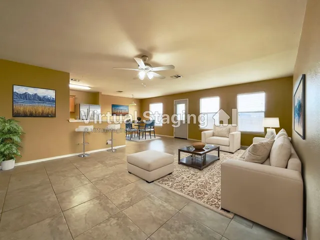 a living room with fireplace furniture and a large window