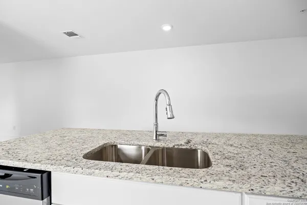 a kitchen with a sink and cabinets