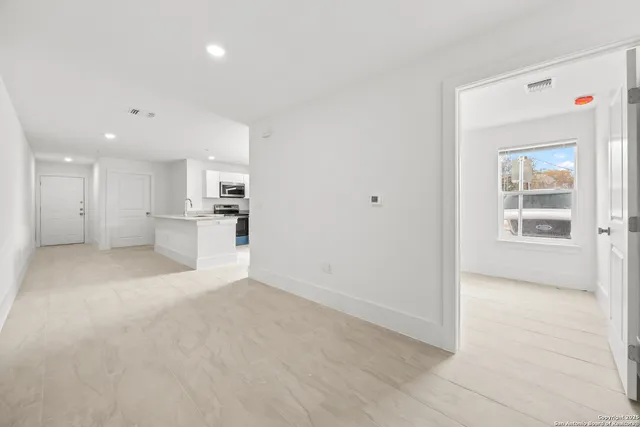 a view of a kitchen with a refrigerator and a sink