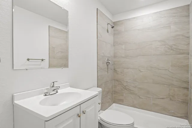 a bathroom with a sink toilet and shower