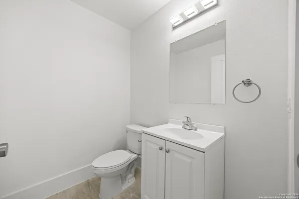 a bathroom with a sink toilet and a mirror
