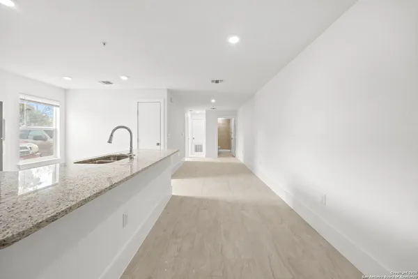 a large kitchen with granite countertop a sink and dishwasher with a large window