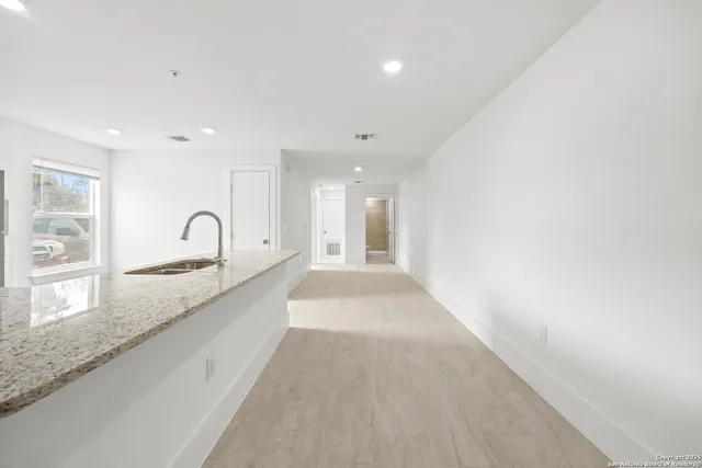 a large kitchen with granite countertop a sink and dishwasher with a large window