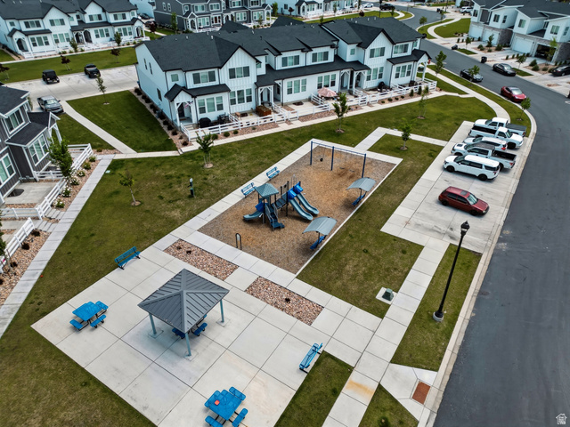 1418 Castillo Road Spanish Fork, UT 84660 - Photo 27 of 40 Community greenspace featuring a playground with swings and slides, a covered picnic area, and additional seating