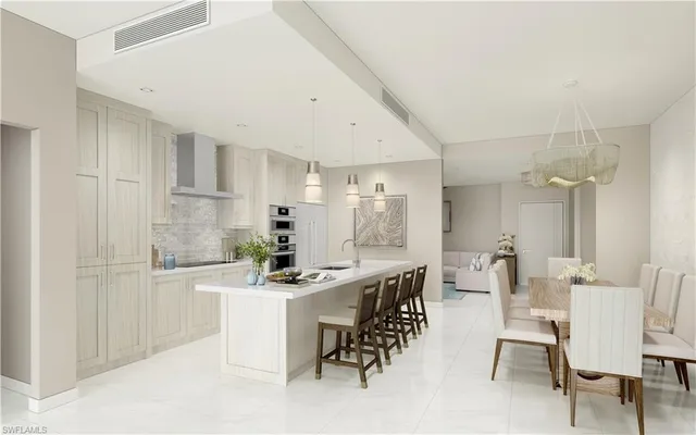 a kitchen with a dining table chairs and white cabinets