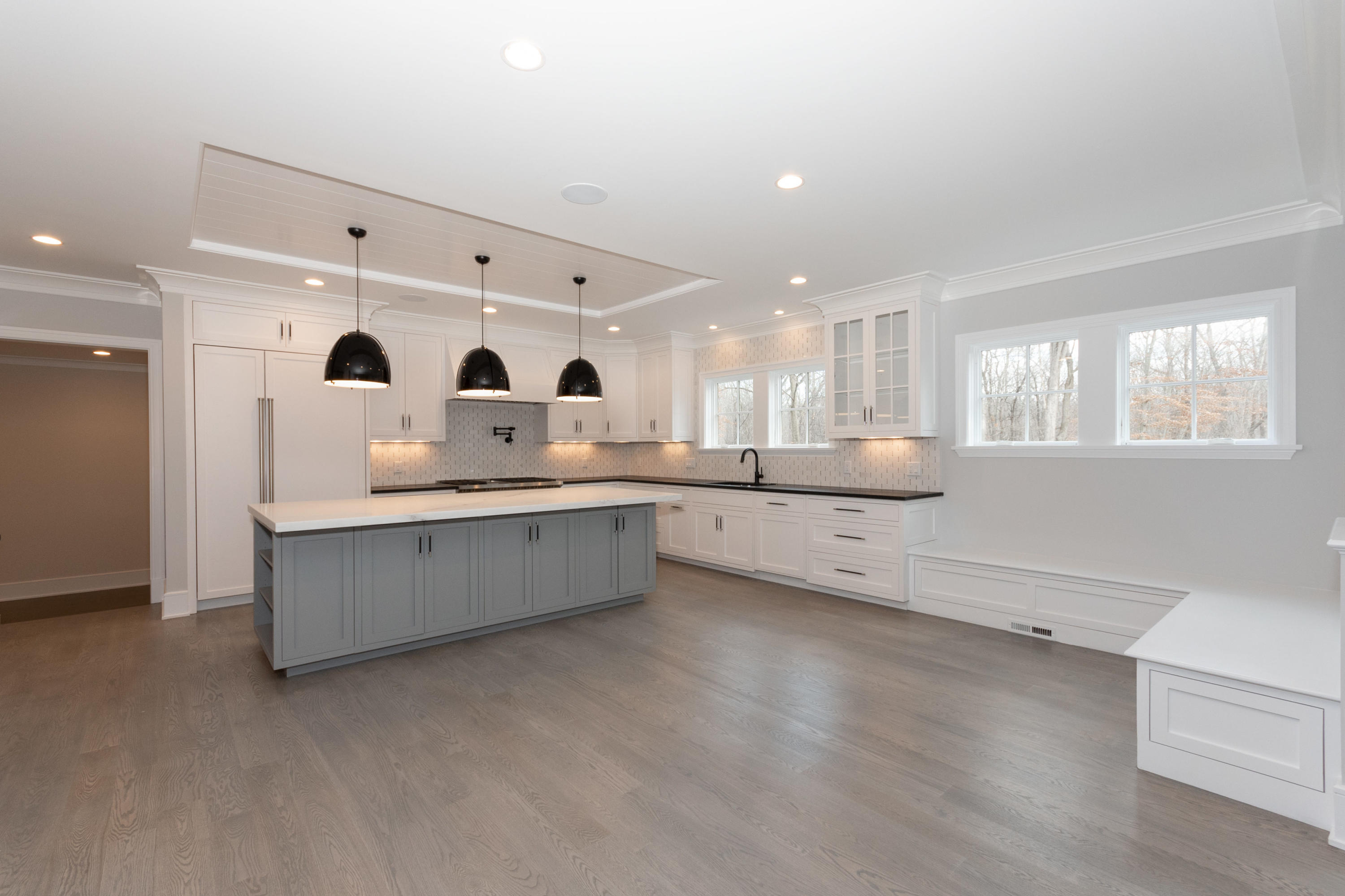 600 Hollow Tree Ridge Road Darien, CT 06820 - Photo 14 of 50 a large white kitchen with stainless steel appliances kitchen island granite countertop a stove a sink a refrigerator and white cabinets