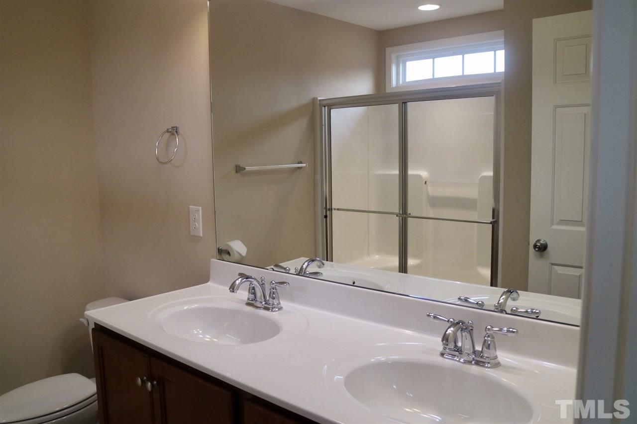 408 Provincial Street Raleigh, NC 27603 - Photo 11 of 24 a bathroom with a sink and a mirror