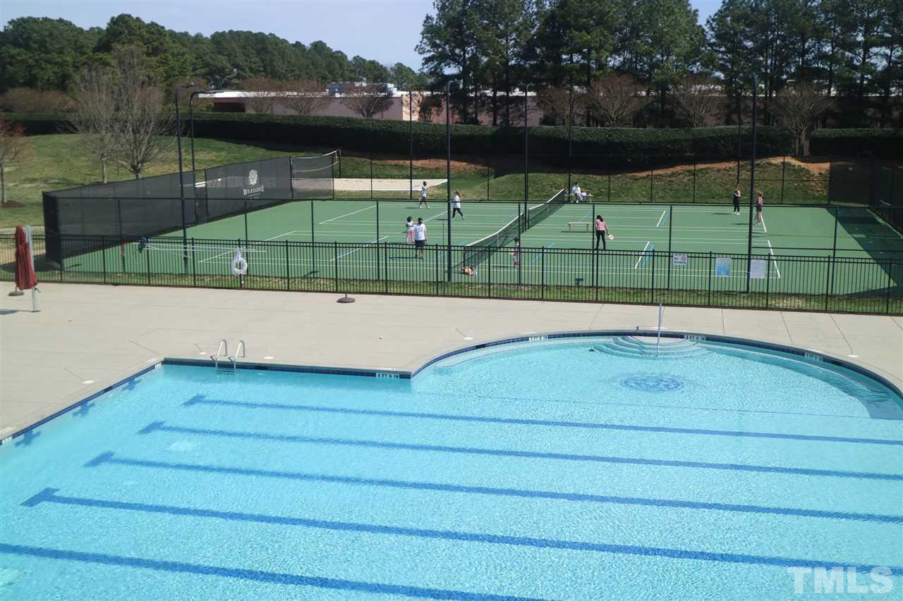 408 Provincial Street Raleigh, NC 27603 - Photo 18 of 24 a view of a swimming pool with a lake view