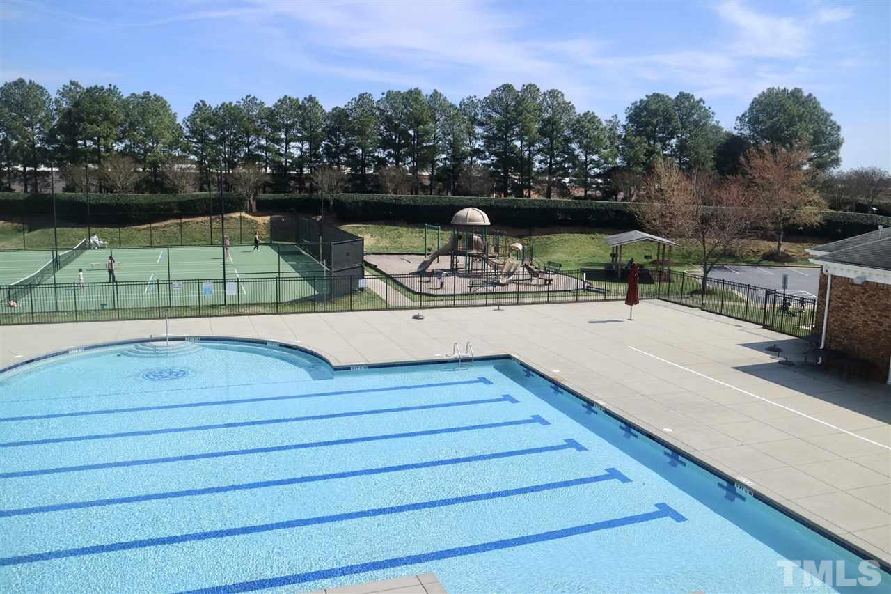 408 Provincial Street Raleigh, NC 27603 - Photo 19 of 24 a view of a swimming pool with a bench and trees