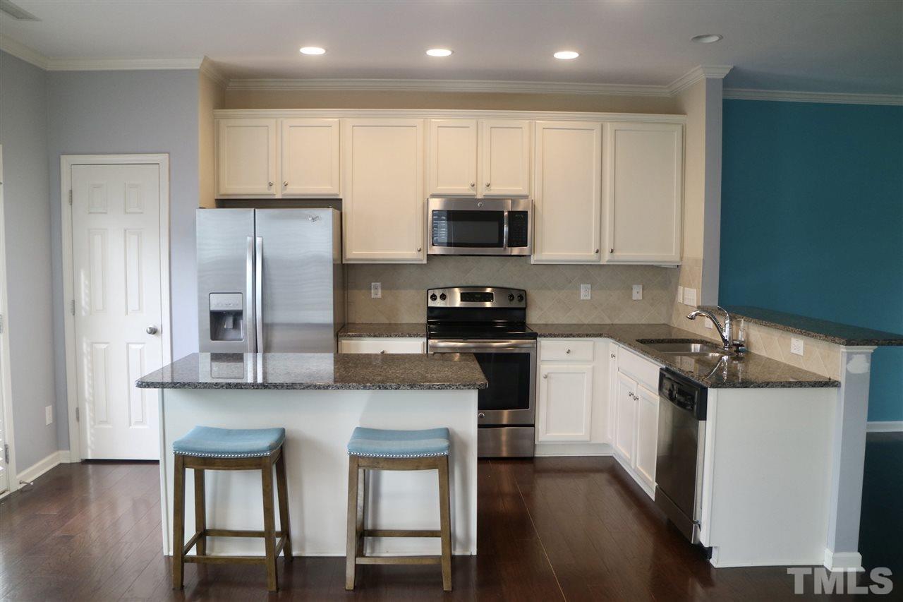 408 Provincial Street Raleigh, NC 27603 - Photo 3 of 24 a kitchen with stainless steel appliances granite countertop a stove a sink and a refrigerator