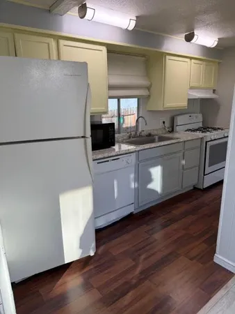 a room with wooden floor and cabinet
