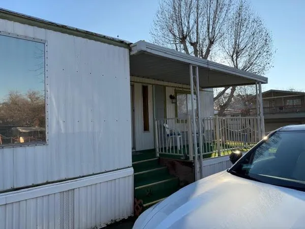 a view of a house with backyard and porch