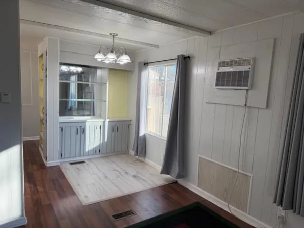 a kitchen with granite countertop stainless steel appliances a sink a stove and cabinets