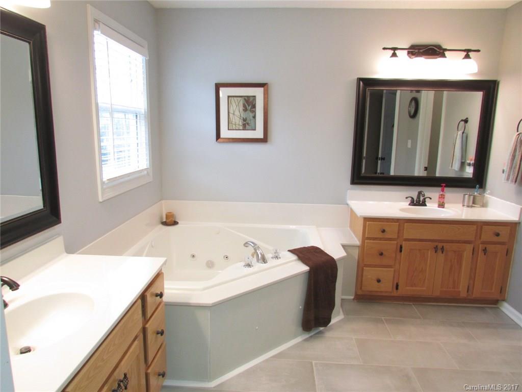 511 Maple Ridge Circle Salisbury, NC 28147 - Photo 14 of 24 a bathroom with a tub sink and mirror