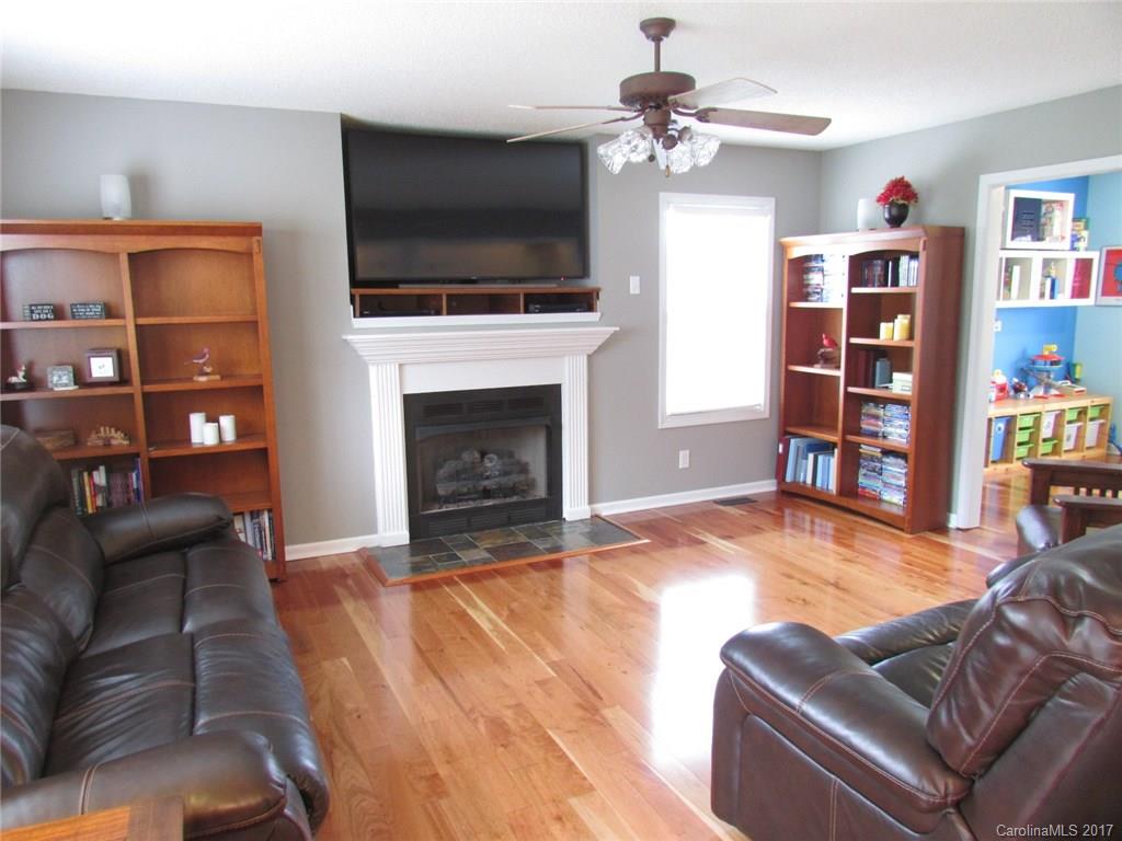 511 Maple Ridge Circle Salisbury, NC 28147 - Photo 3 of 24 a living room with furniture a flat screen tv and a fireplace