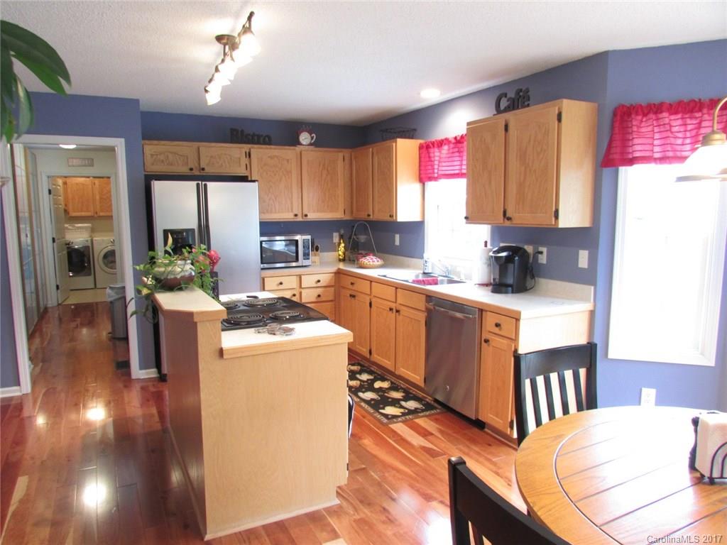 511 Maple Ridge Circle Salisbury, NC 28147 - Photo 5 of 24 a kitchen that has a lot of cabinets a sink and a stove in it