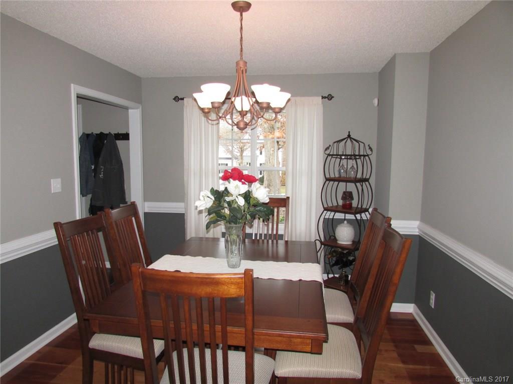 511 Maple Ridge Circle Salisbury, NC 28147 - Photo 7 of 24 a dining room with furniture potted plants and wooden floor