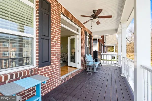 a kitchen with stainless steel appliances granite countertop a refrigerator a stove a sink and white cabinets with wooden floor