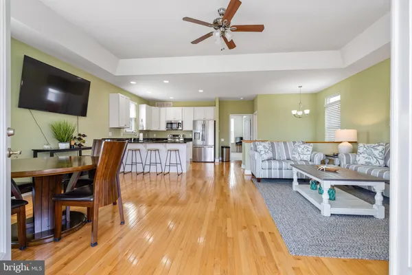 a kitchen with stainless steel appliances granite countertop a refrigerator sink and stove