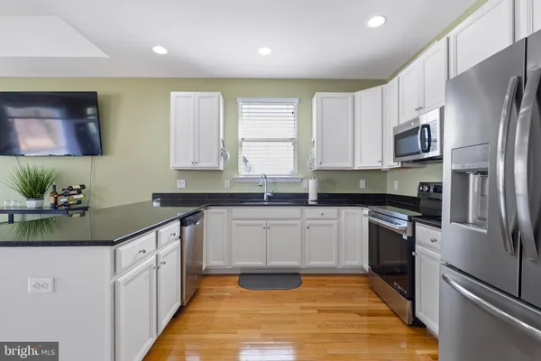 a bathroom with a double vanity sink mirror and toilet