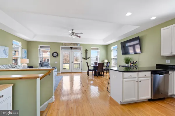 a view of a house with a yard and potted plants