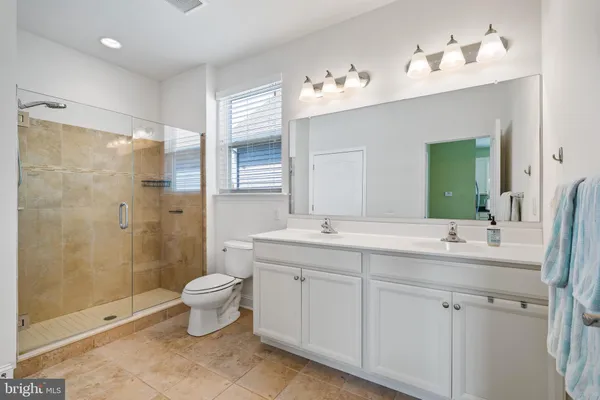 a view of a house with a yard and potted plants