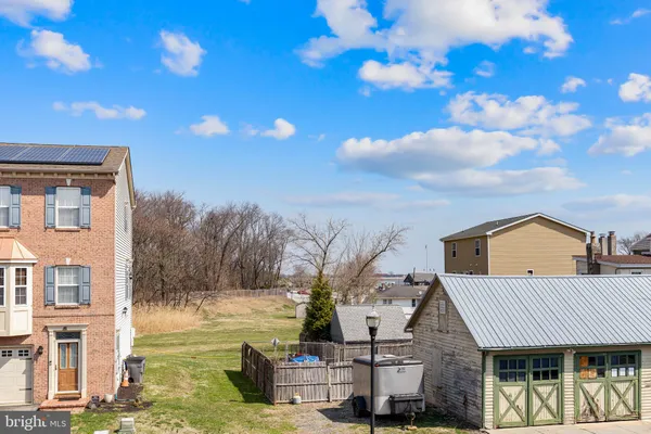 a large yard with lots of green space and tree