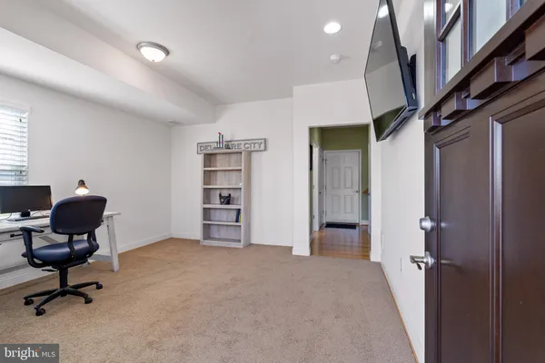a view of a livingroom with workspace and a window