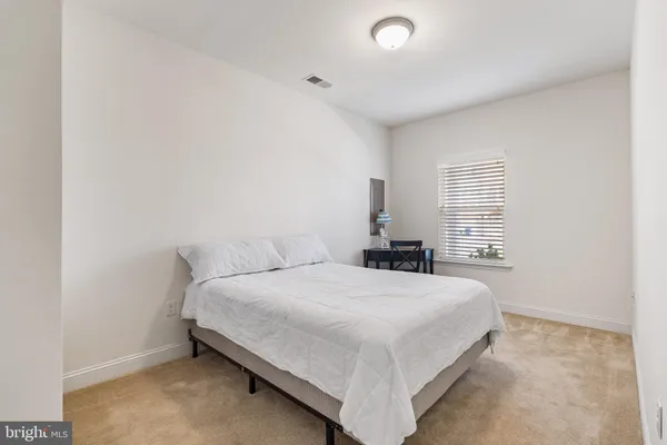 a dining room with furniture a chandelier and wooden floor
