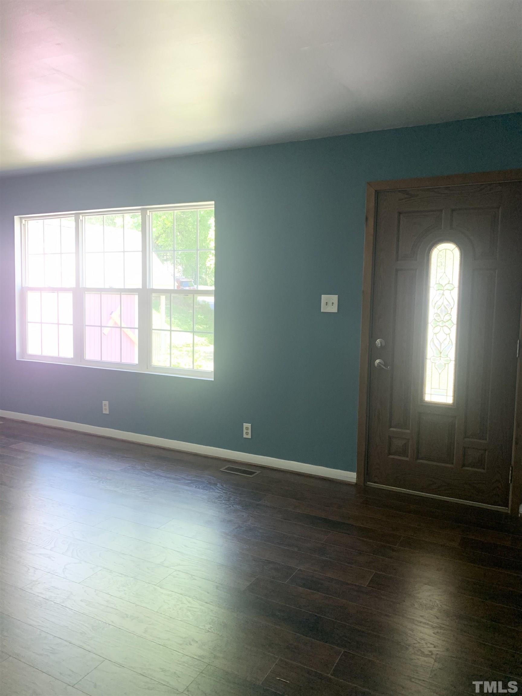 1804 Robinhood Road Durham, NC 27701 - Photo 3 of 25 an empty room with wooden floor and windows