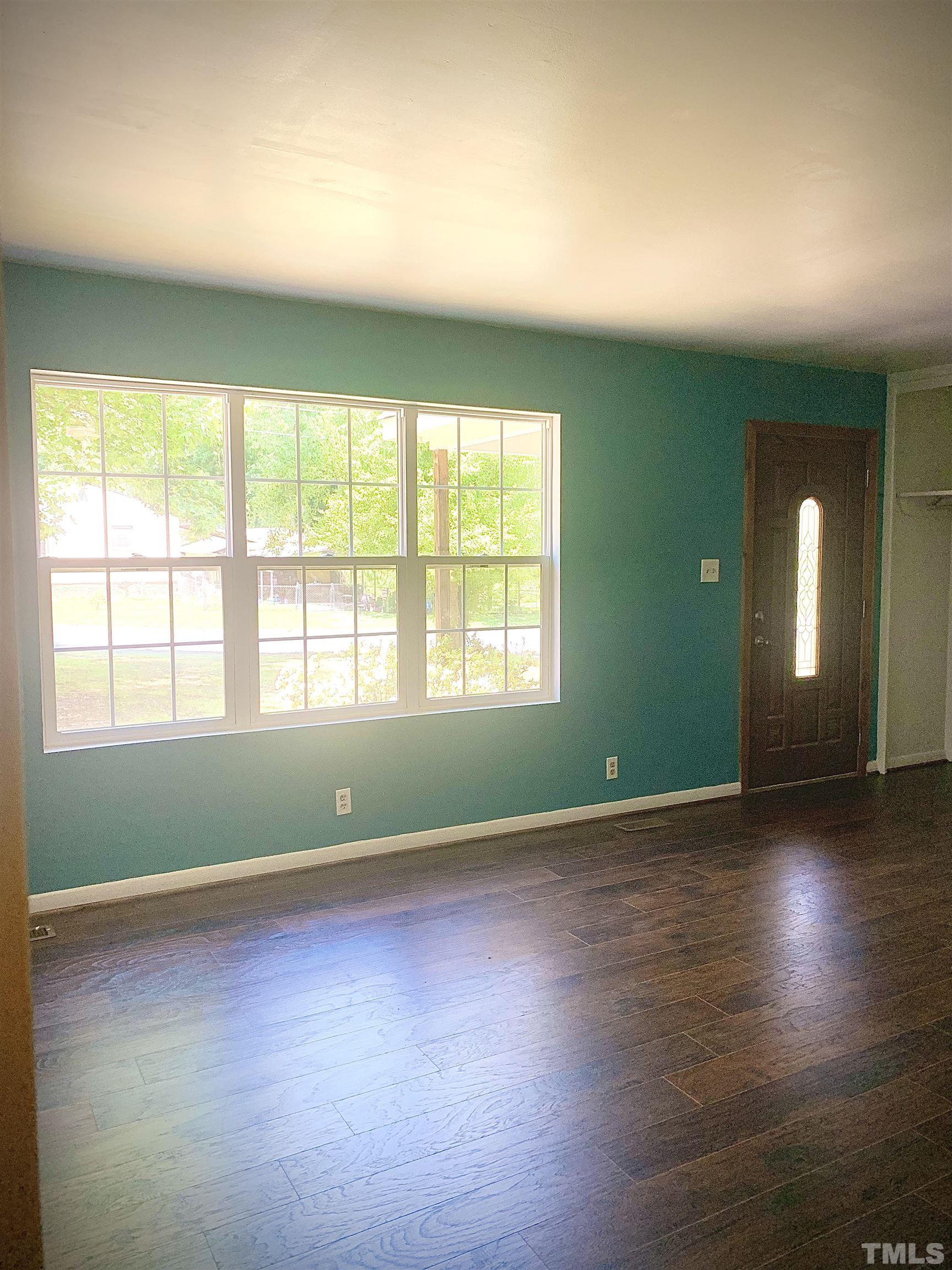 1804 Robinhood Road Durham, NC 27701 - Photo 5 of 25 an empty room with wooden floor and windows