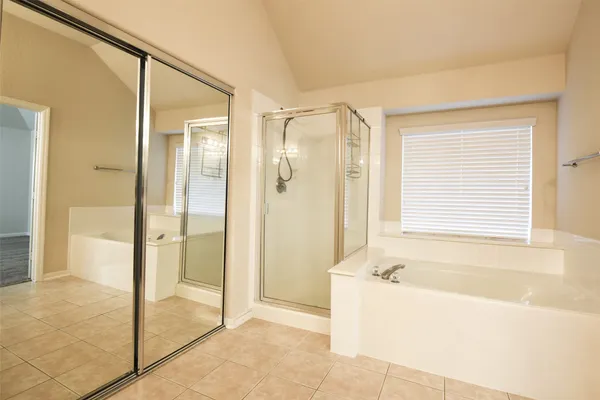 a bathroom with a bathtub and a shower