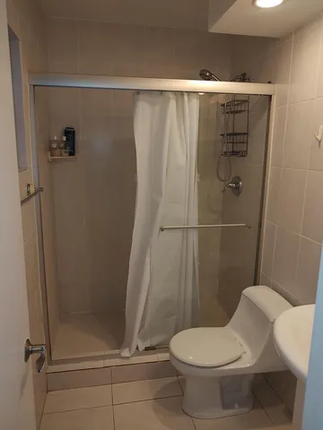 a bathroom with a toilet and a shower